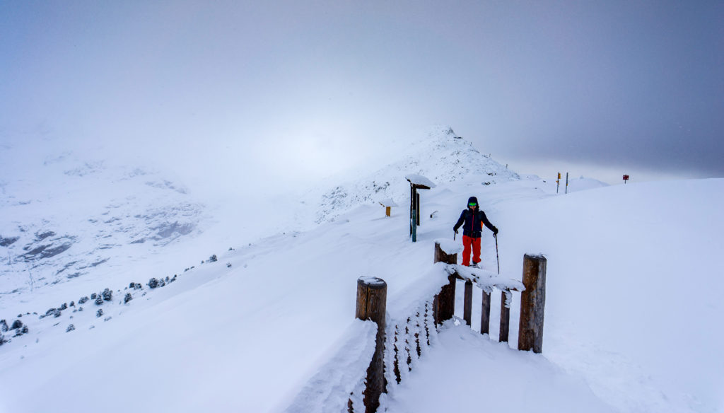 The Aletsch Glacier to the left is hidden by snow and dense clouds